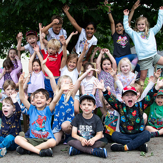 Smiling children at Atlas Camps holiday club—refer a friend, enjoy a free day